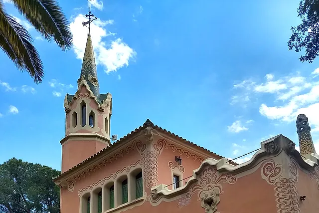 The Gaudí House Museum in Park Güell: the pink-walled house with a pointed tower, seen from outside