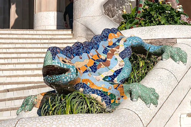 El Drac, the mosaic salamander fountain on the entrance stairway of Park Güell, covered in blue, green and yellow tile fragments